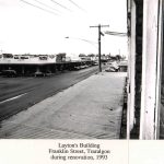 Black and white phot of view looking north down Franklin street Traralgon showing cars and stores