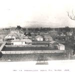 Historic photo of Traralgon township 1888 showing wooden fences, small wooden homes, shops and surrounding farmland and bush