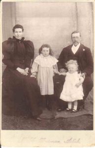 Historic portrait photo of family with father, mother and two young girls