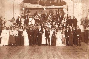 Historic sepia photo of approx 100 people at a ball in the Mechanics Institue hall in Traralgon 1904