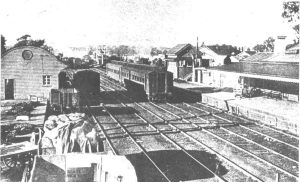 Historic photo looking down at the Traralgon Railway station showing carriages and railway buildings 1923