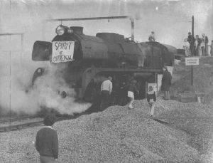 Historic photo of steam train cooling down and crowd of people around it in 1974