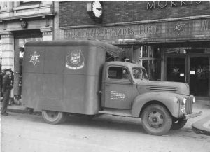 Historic photo of Salvation Army truck outside a building