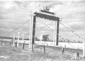 Historic photo of decorated railway line flags and archwayfor the visit of Queen Elizabeth to traralgon in 1954