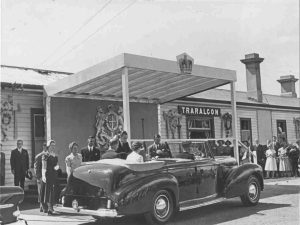 Historic photo of Queen Elizabeth in black open top car with people watching, when visiting Traralgon in 1954