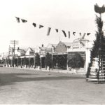 Historic photo of Franklin Street Traralgon with dirt street, decorated with flags and plants for the Traralgon Centenary in 1946