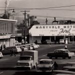 Black and white photo looking south in Franklin street at Maryvale Motors building, with 1950-1960s cars and trucks parked and on the road infront
