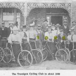 Historic photo of 19 men and women with their push bikes