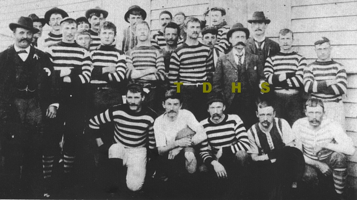 Historic photo of football team wearing striped uniforms 1900