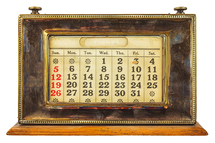 Image of vintage calendar with metal frame, printed numbers of the month and a wooden base